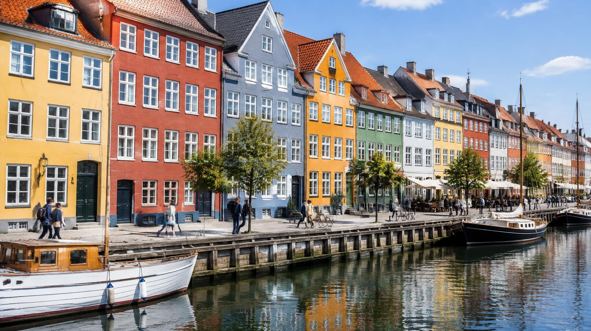 Street view of a colorful Danish town with people walking